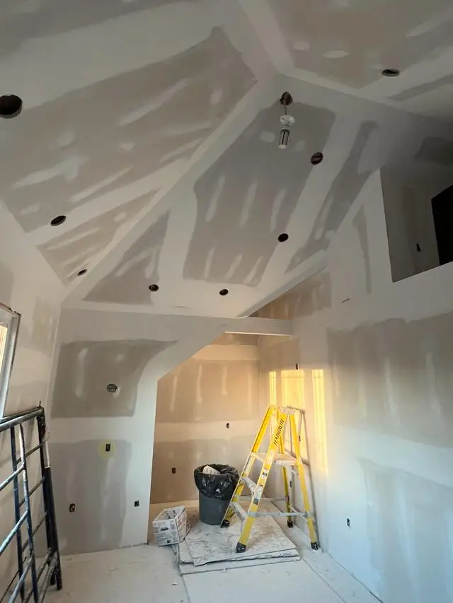 Drywall seams being taped, mudded, and sanded to prepare for paint